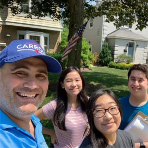 Pictured: Rep. Carroll takes a selfie with his student interns while out knocking doors and speaking to community residents.