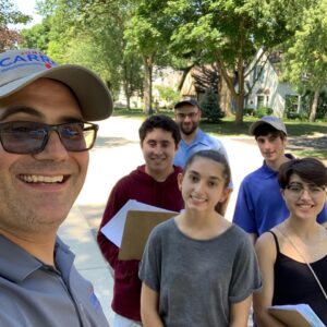 Pictured: Rep. Carroll takes a selfie with his student interns while out knocking doors and speaking to community residents.