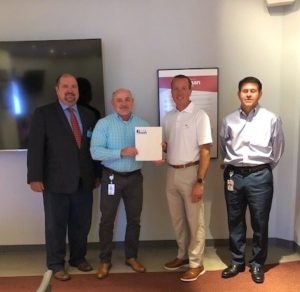 Reitz (middle right) is pictured with Randy Prince from IMA, presenting the ETIP grant to Eastman Chemical Company.