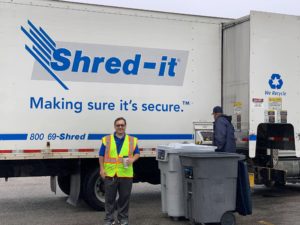 Pictured: Andrade with a paper shredding truck at Roosevelt High School in Albany Park.