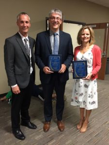 Pictured: State Rep. Mike Halpin (center) with Jennifer Jacobs (right), receiving awards for their roles in new legislation keeping students safe.