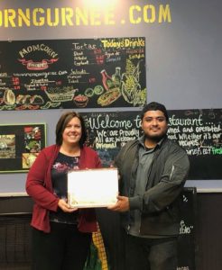 State Rep. Joyce Mason presents Ricardo Soriano, owner of Momcorn, with a certificate for being recognized as a “Good Neighbor” Business of the Month in Gurnee.
