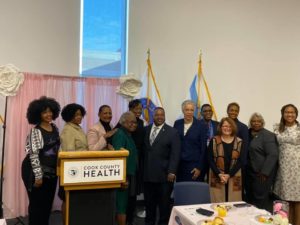 Pictured: State Rep. Camille Y. Lilly, third from right, with Cook County Board President Toni Preckwinkle, right center, and Cook County Commissioner Dennis Deer, left center.