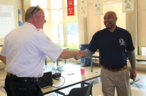 State Rep. Justin Slaughter (right) greets a lieutenant from the Chicago Police Department.