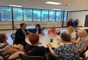 Yingling (left) talks to a group of seniors at the Round Lake Senior Center.