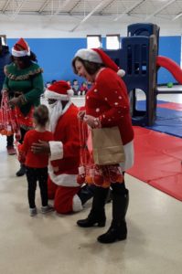 Photo: State Rep. Monica Bristow and Rosetta Brown help Santa hand out treats to the kids at St. Francis Daycare at St. Anthony’s Hospital in Alton on Monday.