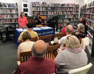 State Senator Rachelle Crowe (left) and state Representative Katie Stuart (right) talk with seniors about preventing identity theft