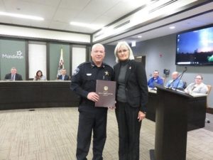 PICTURED: State Rep. Mary Edly-Allen presents Mundelein Chief of Police Eric Guenther with a resolution adopted by the Illinois House of Representatives. The American Medical Association recently recognized Guenther with the Dr. Nathan Davis Award for Outstanding Government Service in recognition of his “A Way Out” program for individuals suffering from addition.