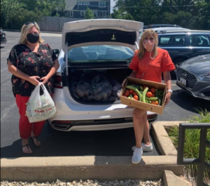 PICTURED: State Rep. Terra Costa Howard accepts fresh produce donations to benefit Glen Ellyn-area food pantries from Illinois Farm Bureau Manager Lindsay McQueen.